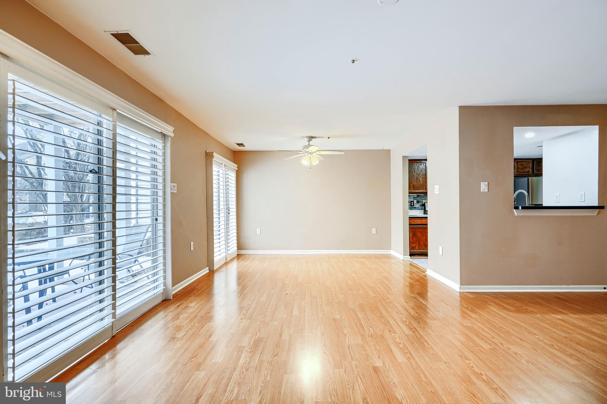 14235 Jib Street, Unit 7342 Laurel, MD 20707 - Photo 15 of 25 a view of an empty room with wooden floor and a window