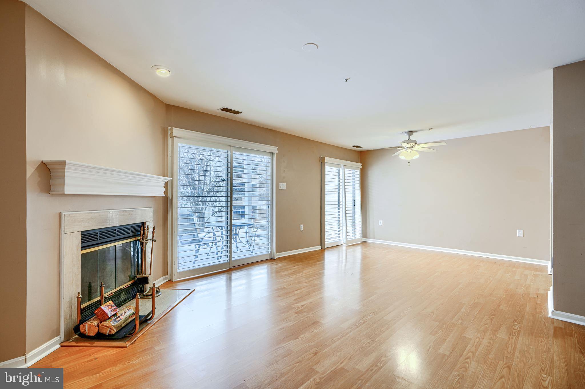 14235 Jib Street, Unit 7342 Laurel, MD 20707 - Photo 18 of 25 a view of an empty room with wooden floor fireplace and a window