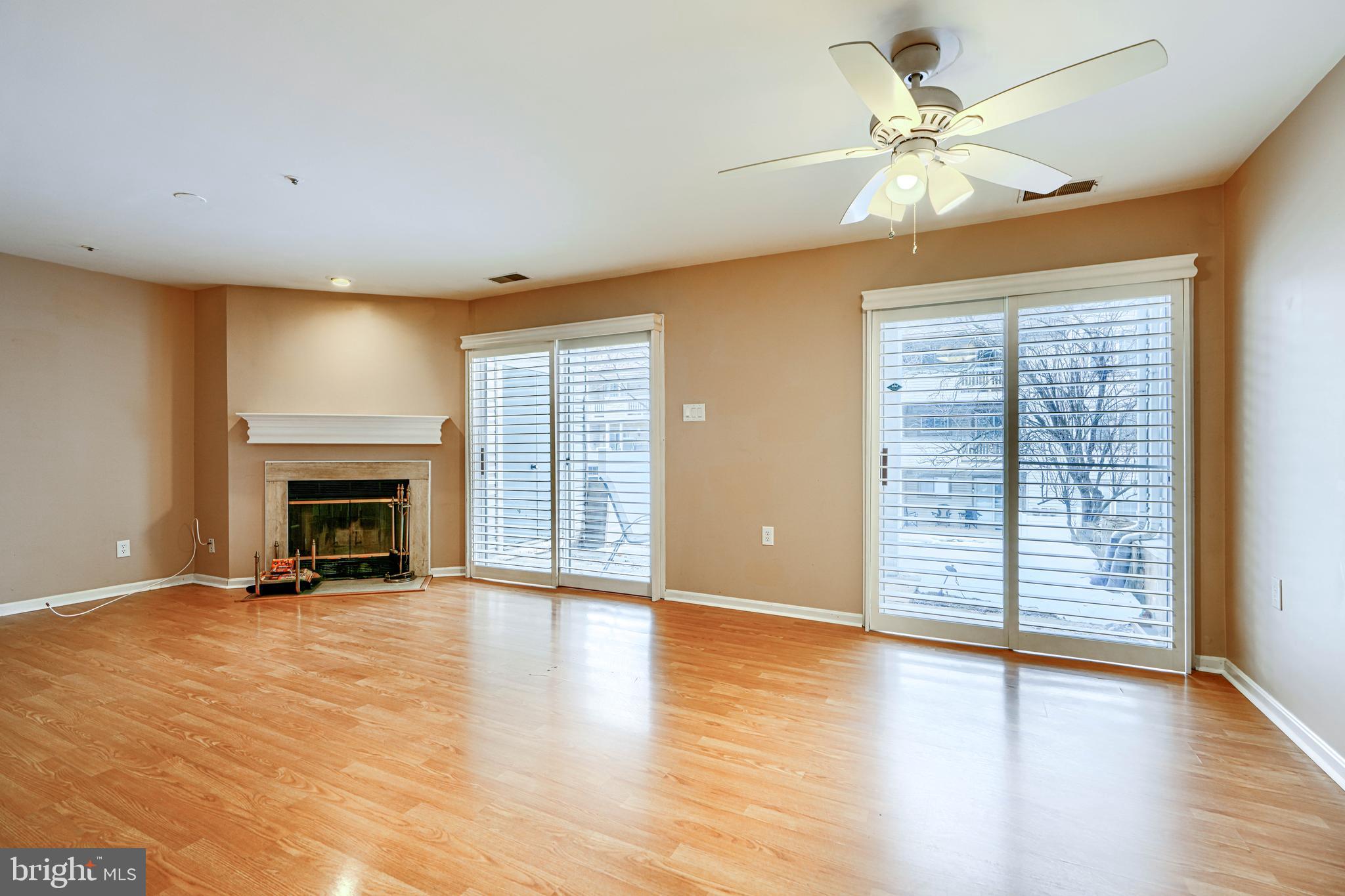 14235 Jib Street, Unit 7342 Laurel, MD 20707 - Photo 20 of 25 an empty room with windows fireplace and wooden floor
