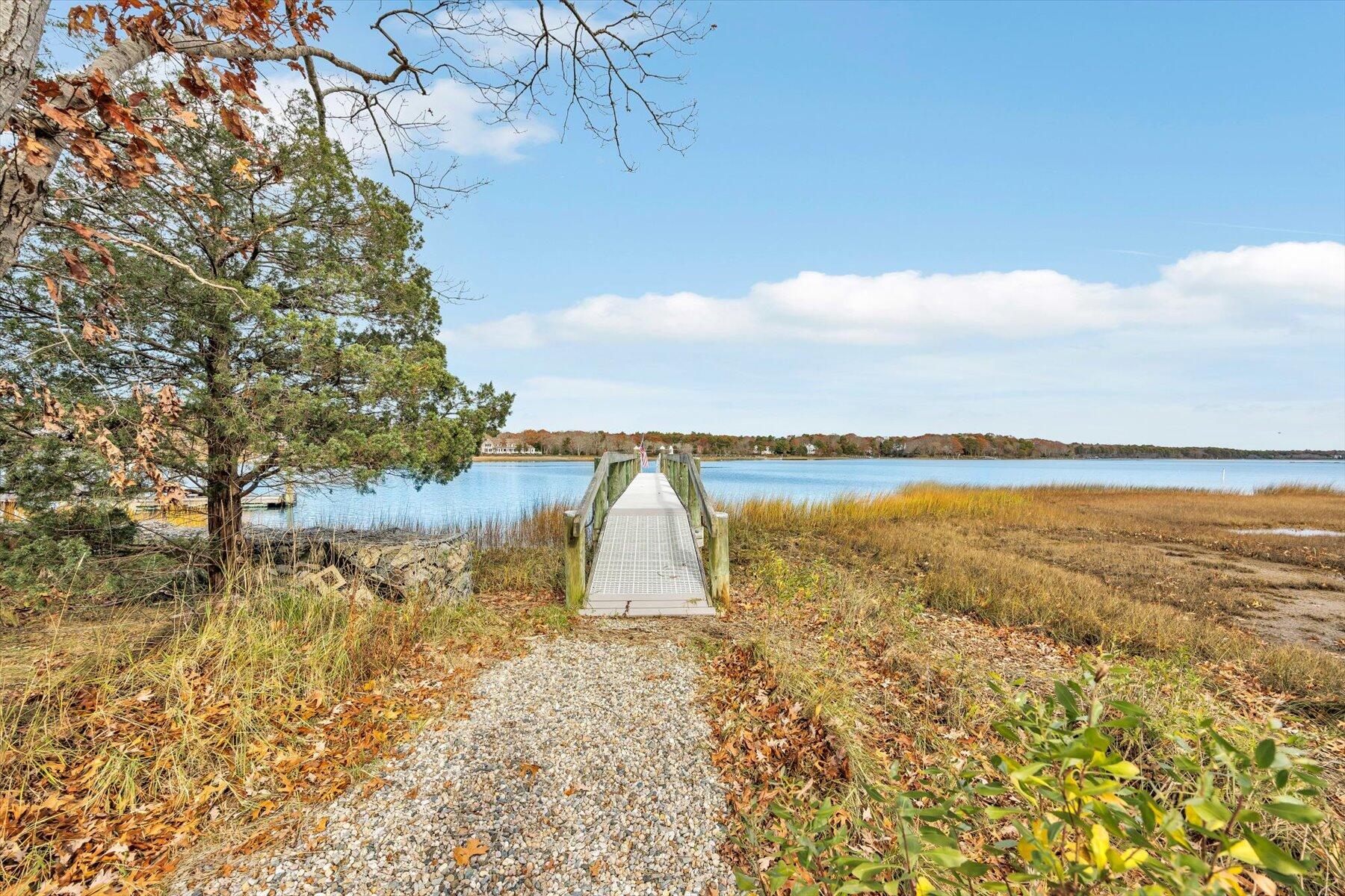 140 Summersea Road Mashpee, MA 02649 - Photo 4 of 39 a view of a lake with a yard and mountain view