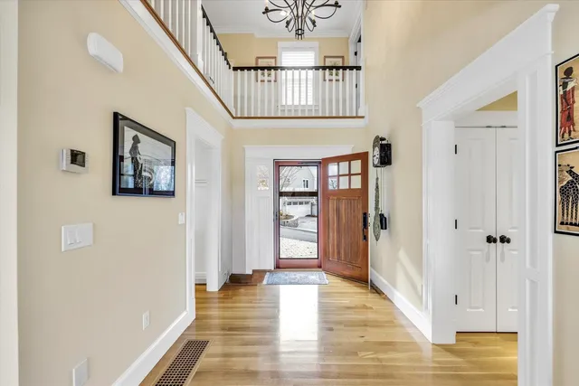 a view of a hallway with wooden floor and windows