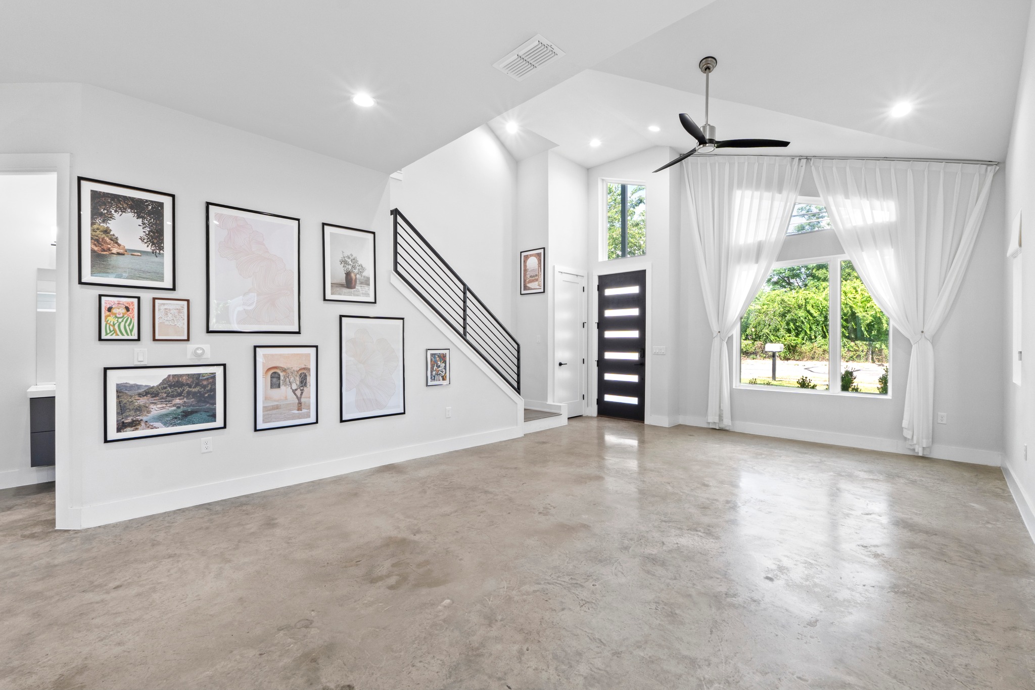 2007 Chestnut Avenue, Unit 1 Austin, TX 78722 - Photo 8 of 32 Natural light streams into this expansive open-concept living area with polished concrete flooring and soaring ceilings.