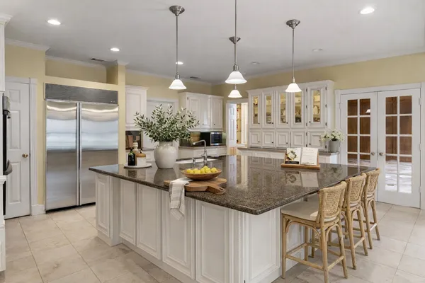 a kitchen with stainless steel appliances granite countertop a stove a sink and a refrigerator