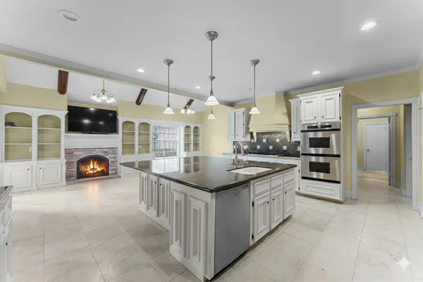 a kitchen with stainless steel appliances granite countertop a stove and a sink