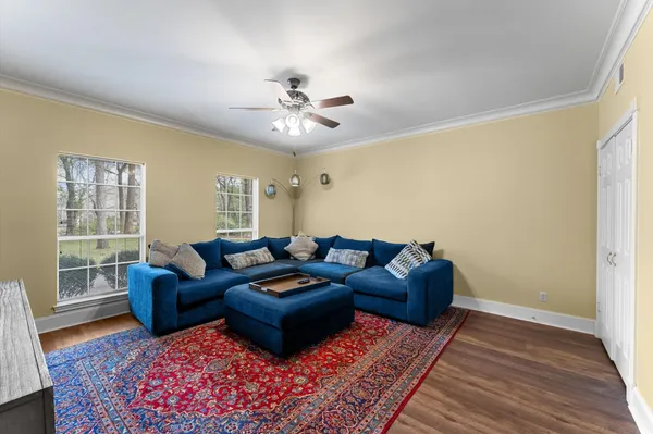 a living room with furniture and wooden floor
