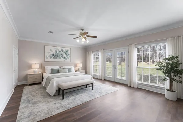 a spacious bedroom with a bed and glass door