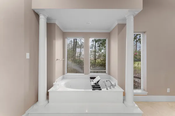 a bath tub sitting in a bathroom next to a window