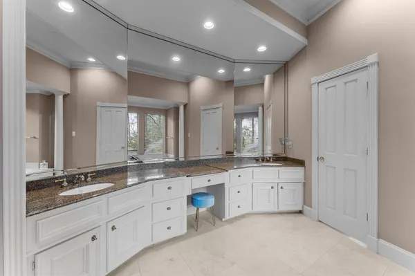 a large bathroom with double vanity and a mirror