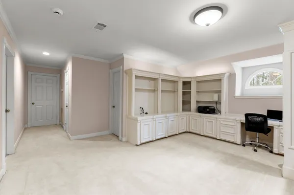 an empty room with furniture and windows