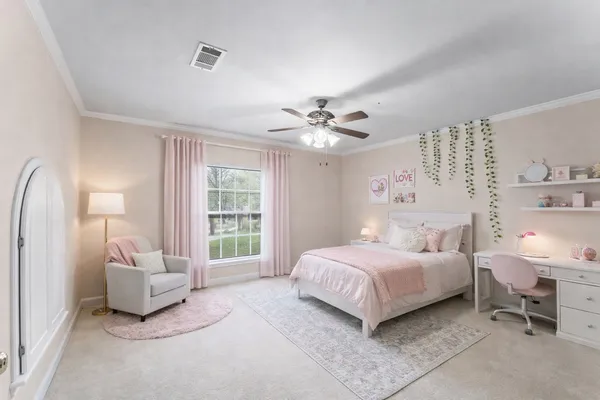 a bedroom with a bed and a chandelier