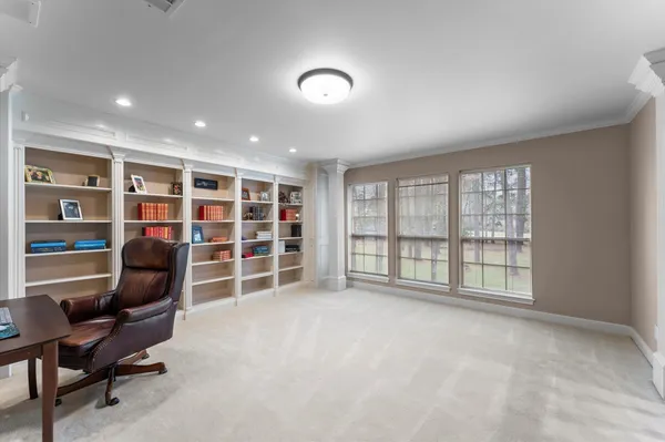 a view of a livingroom with furniture and staircase