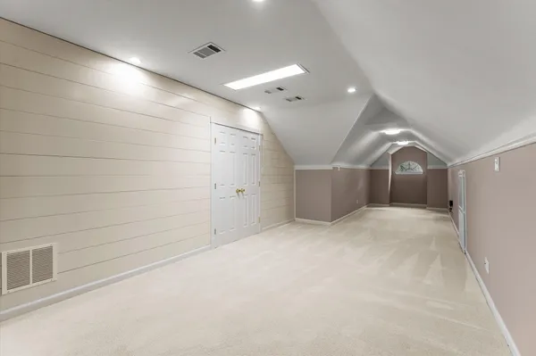 a bedroom with a bed and a night stand