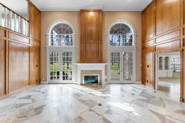 a view of a livingroom with a fireplace wooden floor and a window