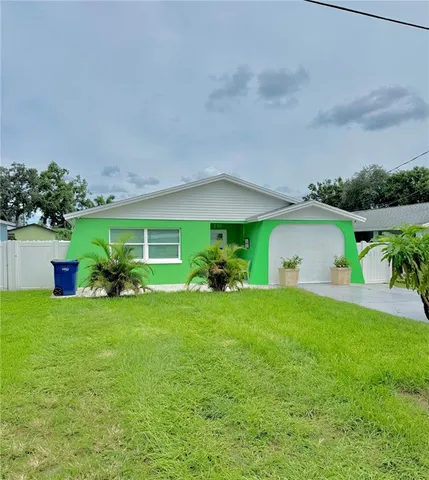 a view of a house with backyard and porch