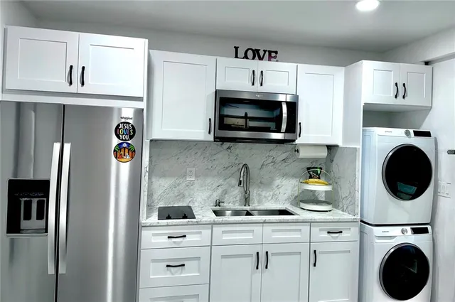 a bathroom with a granite countertop toilet sink and mirror