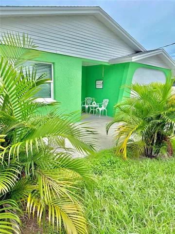 a house with a yard and potted plants