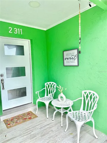 a view of a chairs and table in patio
