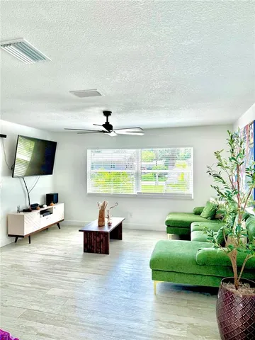 a living room with furniture and a large window