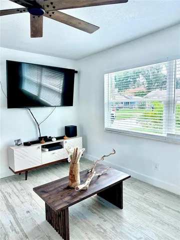 a living room with furniture and flat screen tv