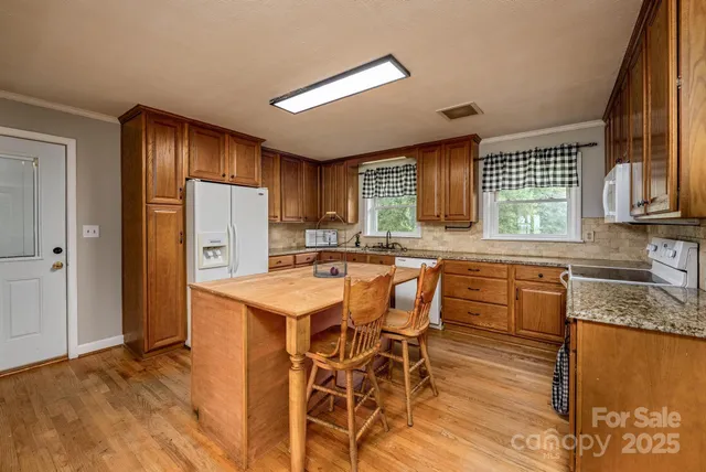 a kitchen with a sink stove and cabinets