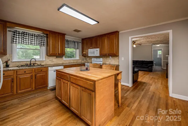 a kitchen with granite countertop cabinets stainless steel appliances and a counter space