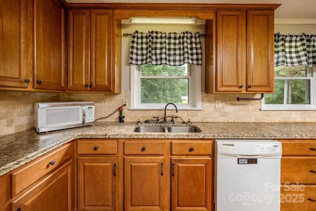 a kitchen with a stove a sink and a microwave