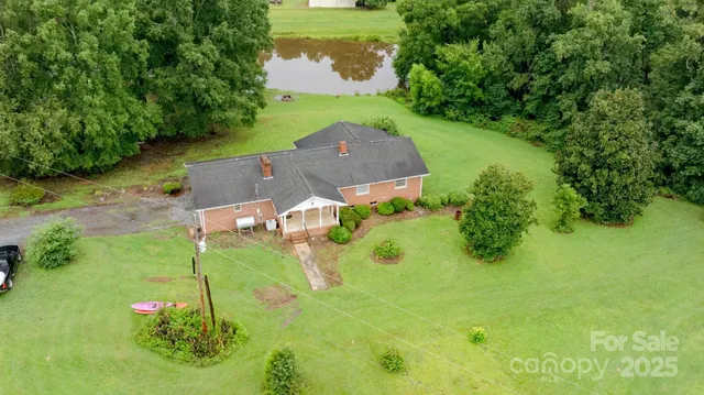 an aerial view of a house with a yard basket ball court and outdoor seating
