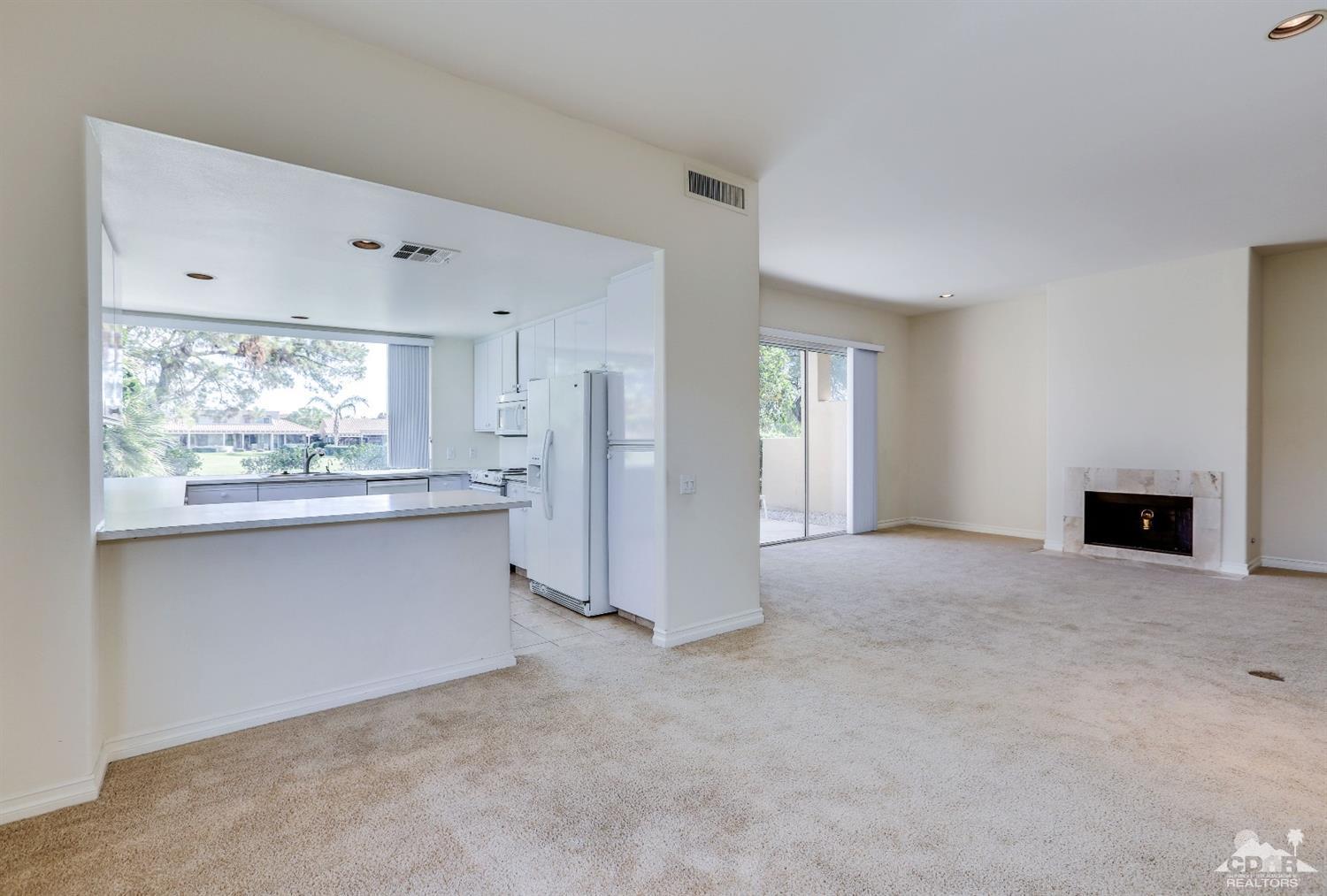 64 Oak Tree Drive Rancho Mirage, CA 92270 - Photo 15 of 31 a view of kitchen with refrigerator and window