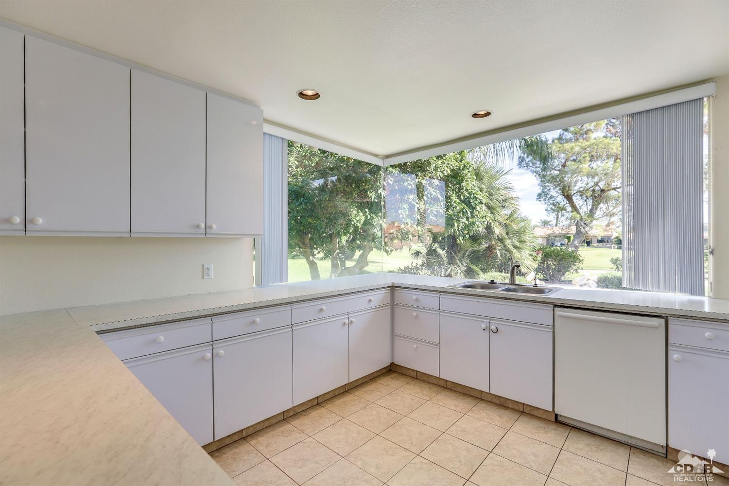 64 Oak Tree Drive Rancho Mirage, CA 92270 - Photo 17 of 31 a view of a kitchen with wooden floor and cabinets