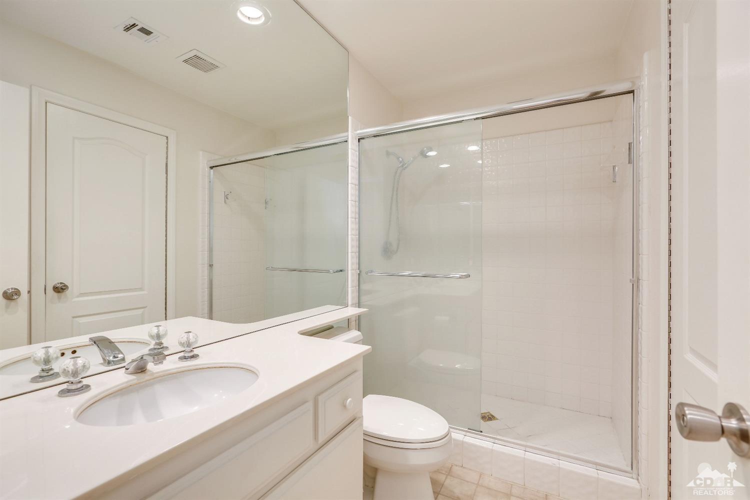 64 Oak Tree Drive Rancho Mirage, CA 92270 - Photo 20 of 31 a bathroom with a shower sink vanity mirror and toilet