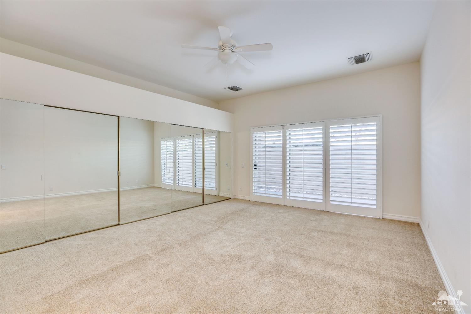 64 Oak Tree Drive Rancho Mirage, CA 92270 - Photo 22 of 31 a view of an empty room with a window