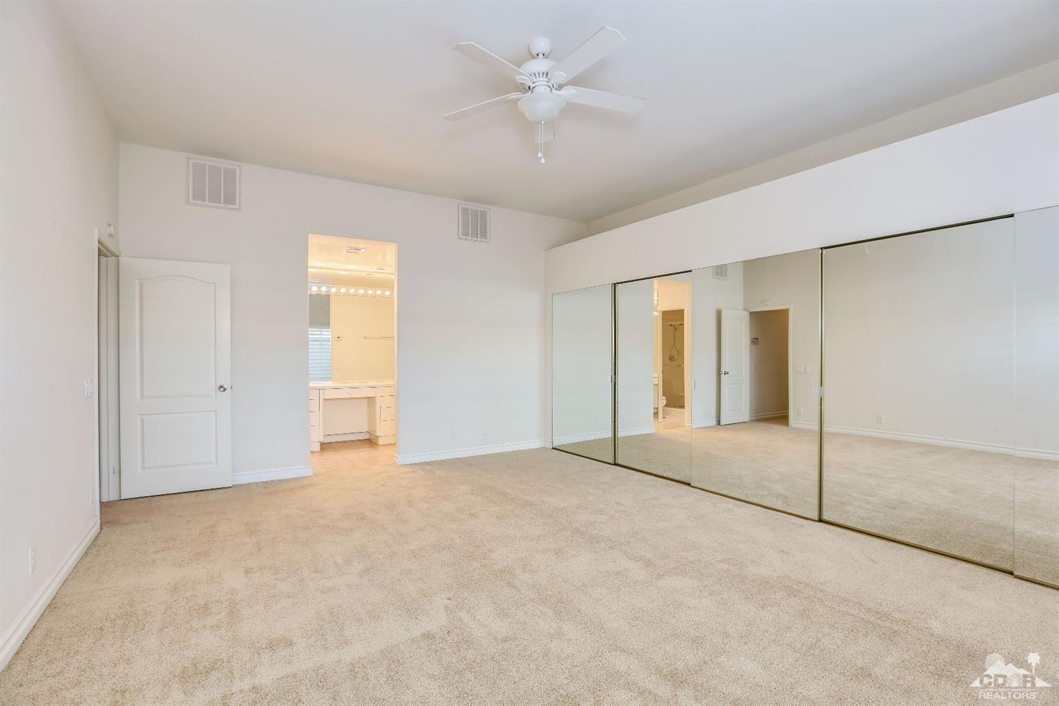 64 Oak Tree Drive Rancho Mirage, CA 92270 - Photo 23 of 31 a view of an empty room with a ceiling fan