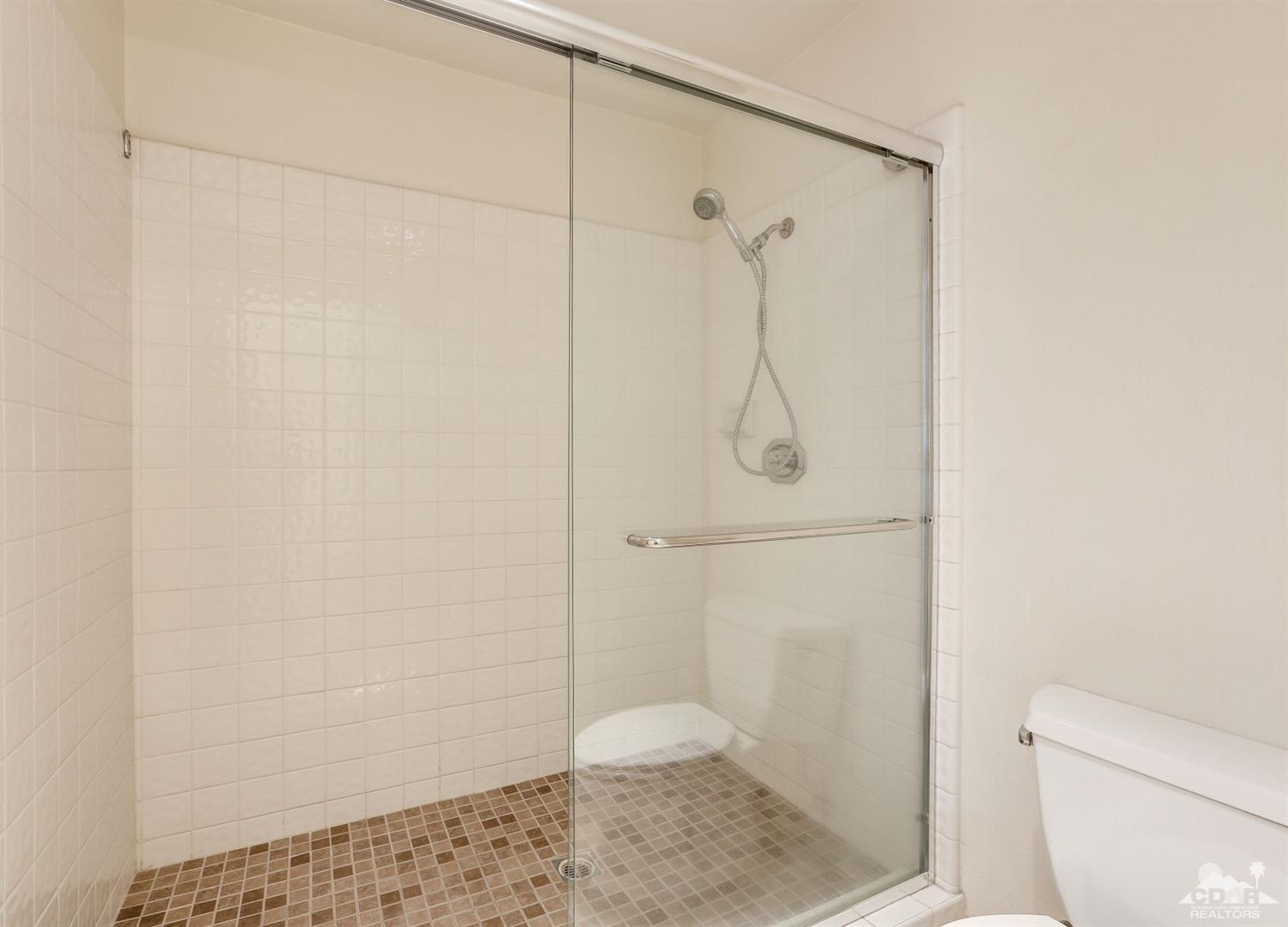 64 Oak Tree Drive Rancho Mirage, CA 92270 - Photo 25 of 31 a bathroom with a shower