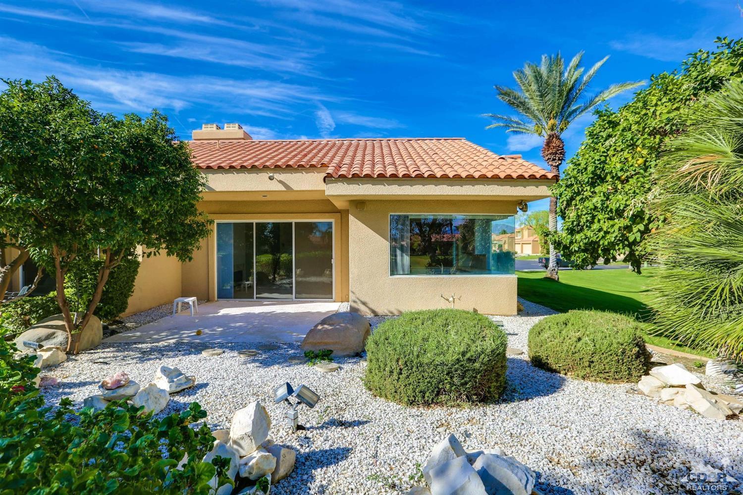 64 Oak Tree Drive Rancho Mirage, CA 92270 - Photo 30 of 31 a view of a house with a backyard