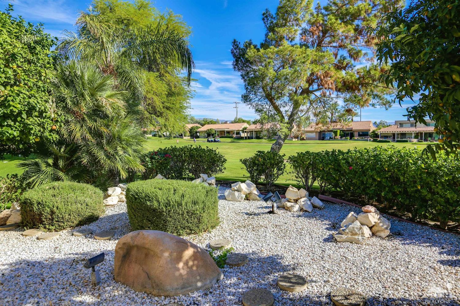 64 Oak Tree Drive Rancho Mirage, CA 92270 - Photo 31 of 31 a view of a backyard with plants and a patio