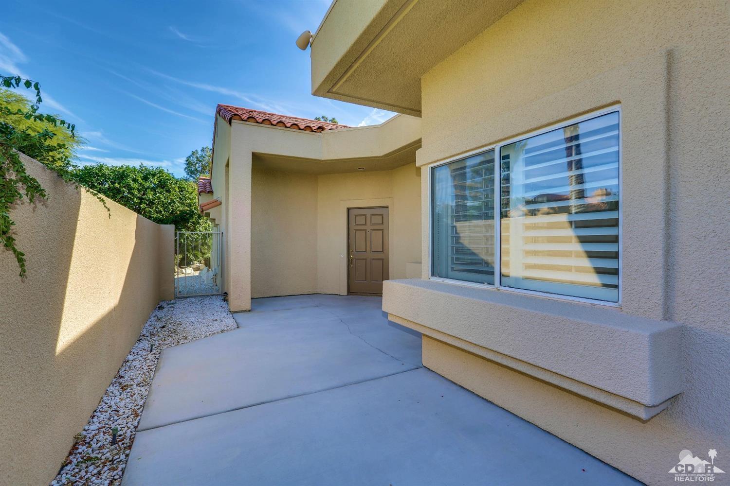 64 Oak Tree Drive Rancho Mirage, CA 92270 - Photo 5 of 31 a view of an entryway with a table and chair