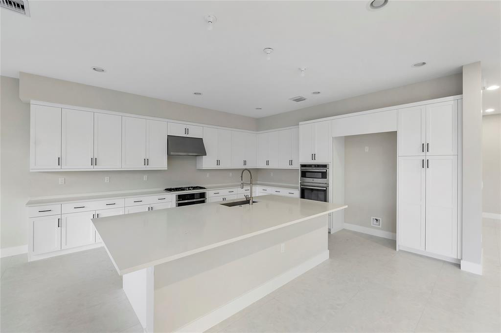 20119 Pacific Dunes Drive Boca Raton, FL 33434 - Photo 16 of 52 a kitchen with stainless steel appliances a refrigerator sink stove and white cabinets
