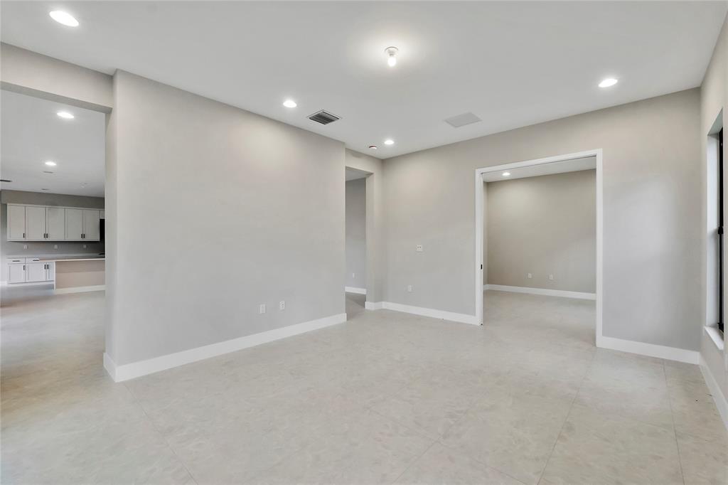 20119 Pacific Dunes Drive Boca Raton, FL 33434 - Photo 17 of 52 an empty room with an entryway and a kitchen