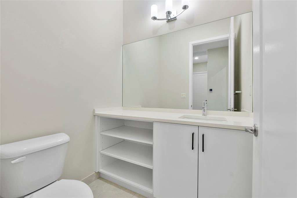 20119 Pacific Dunes Drive Boca Raton, FL 33434 - Photo 18 of 52 a bathroom with a toilet sink and mirror