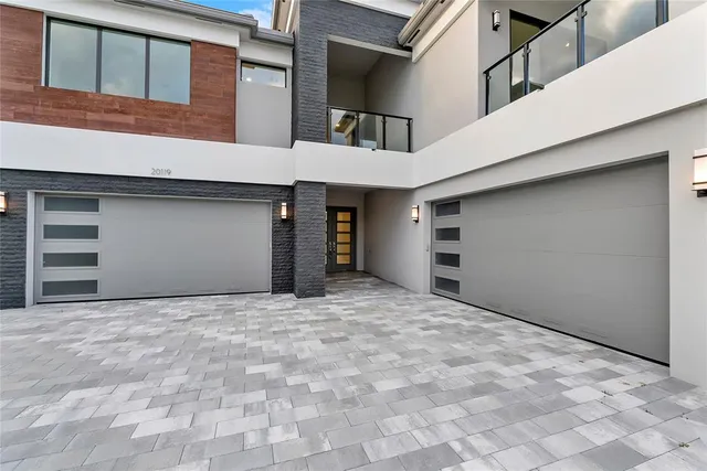 a large kitchen with stainless steel appliances lots of counter space and a sink