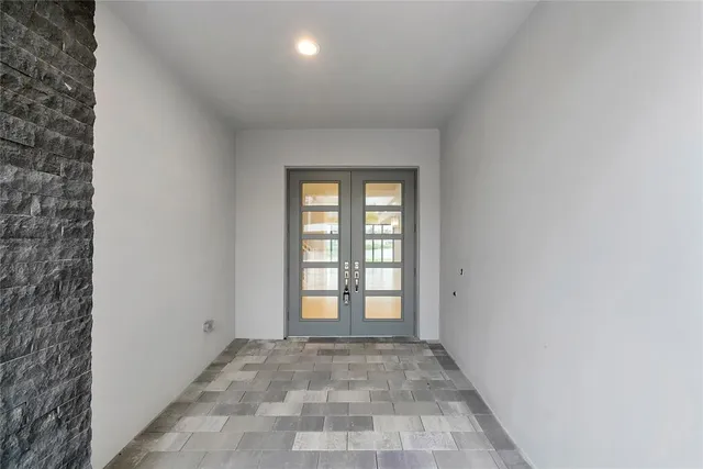 a kitchen that has a lot of cabinets and wooden floor