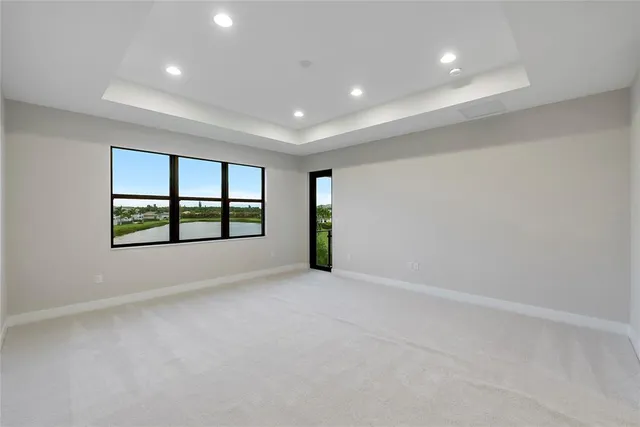 a spacious bathroom with a double vanity sink a large mirror and shower