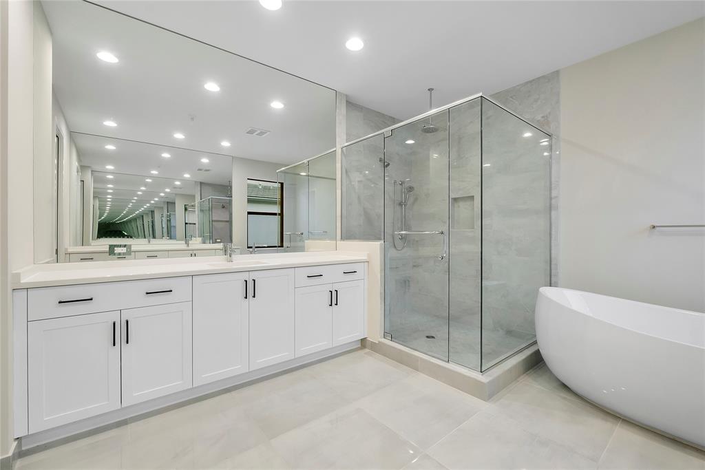 20119 Pacific Dunes Drive Boca Raton, FL 33434 - Photo 23 of 52 a spacious bathroom with a double vanity sink a large mirror and shower