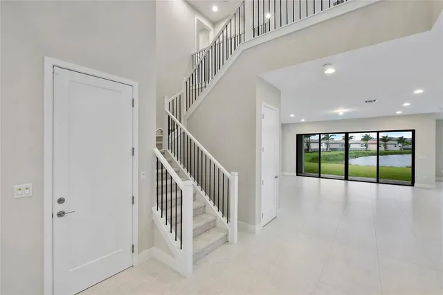 an empty room with an entryway and a kitchen