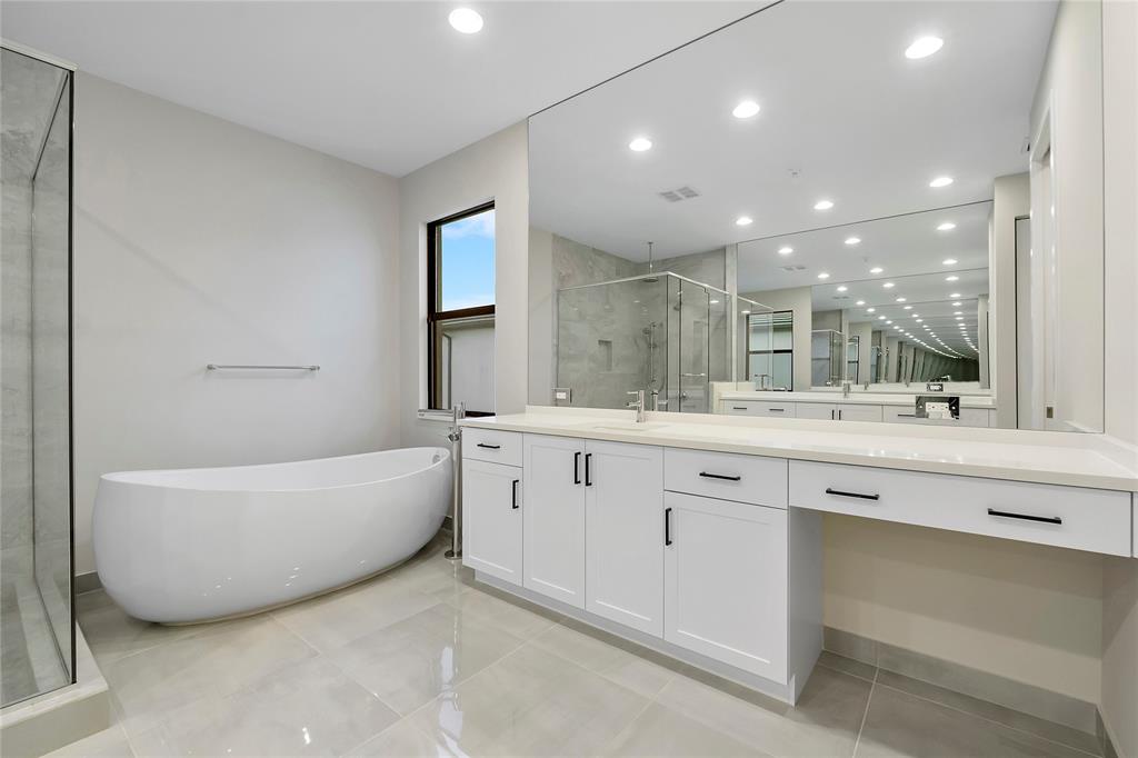 20119 Pacific Dunes Drive Boca Raton, FL 33434 - Photo 24 of 52 a bathroom with a tub a sink shower and mirror