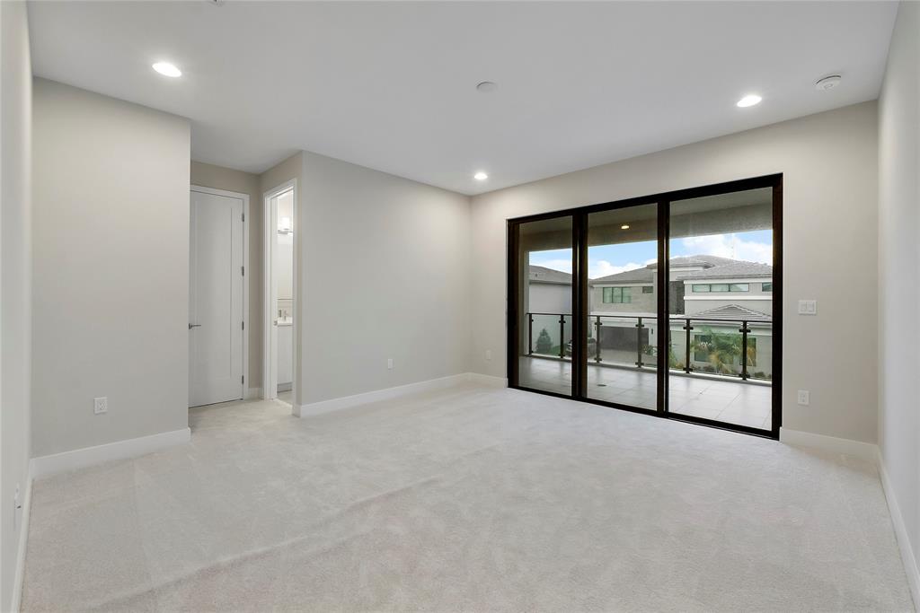 20119 Pacific Dunes Drive Boca Raton, FL 33434 - Photo 25 of 52 a view of an empty room with a sliding door