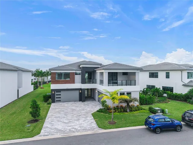 a front view of a house with a garden and yard