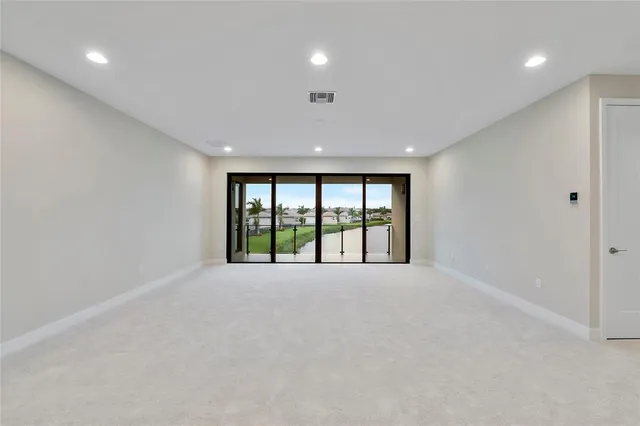 an aerial view of a city with lots of residential buildings and mountain view in back