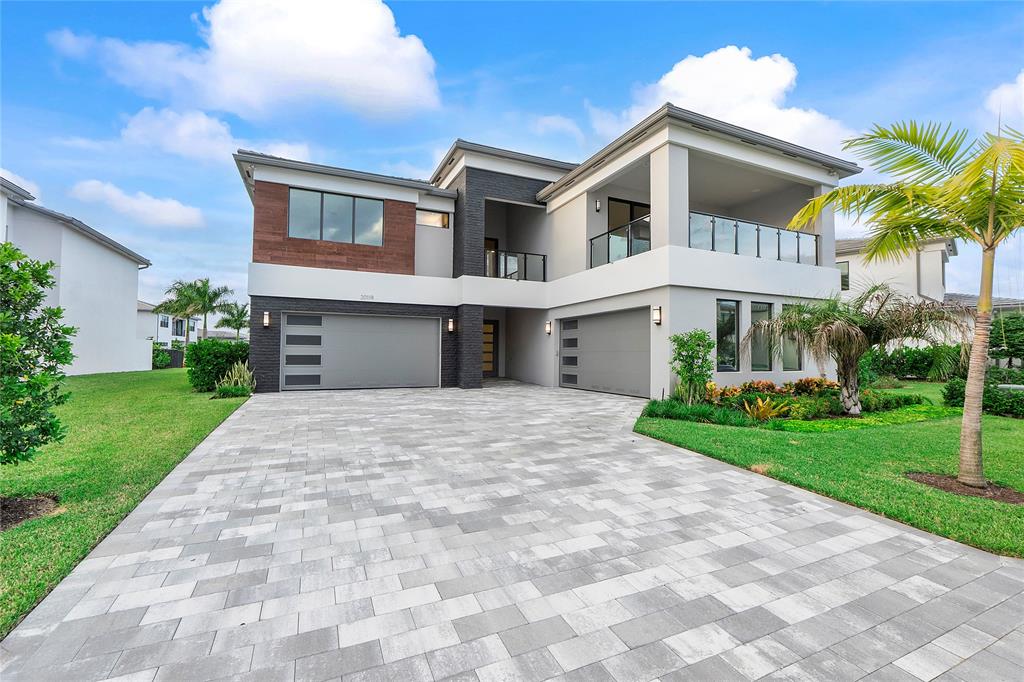 20119 Pacific Dunes Drive Boca Raton, FL 33434 - Photo 8 of 52 a front view of a house with a yard and a garage