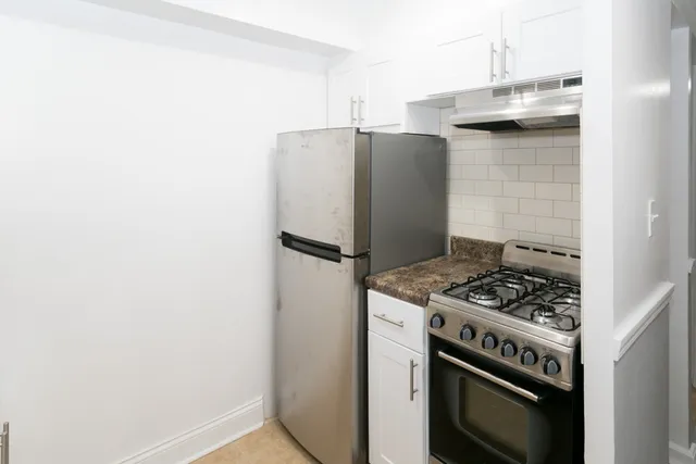 a kitchen with stainless steel appliances granite countertop a stove and a refrigerator